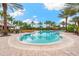 Large community pool with lounge chairs, palm trees, and poolside dining at 5121 Serata Dr, Lakewood Ranch, FL 34211