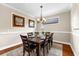 Dining room featuring a wood dining table, decorative light fixture, and neutral wall color at 5121 Serata Dr, Lakewood Ranch, FL 34211