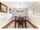 Dining room features a wood table, crown molding, neutral walls and is decorated with tasteful art at 5121 Serata Dr, Lakewood Ranch, FL 34211