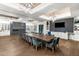 An elegant dining room features a long table with plush seating, recessed ceilings, and a decorative fireplace at 5121 Serata Dr, Lakewood Ranch, FL 34211