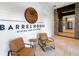 Barrel House Bistro and Tap Room entrance with leather chairs at 5121 Serata Dr, Lakewood Ranch, FL 34211