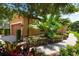 Manicured landscaping with a brick pathway and a peek at the garage at 5121 Serata Dr, Lakewood Ranch, FL 34211