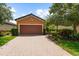 Charming home with a brick driveway and lush, green landscaping at 5121 Serata Dr, Lakewood Ranch, FL 34211