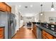 Kitchen with wood cabinets, stainless steel appliances, granite countertops, and breakfast bar open to dining area at 5121 Serata Dr, Lakewood Ranch, FL 34211