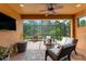 Screened lanai offering outdoor seating, a ceiling fan, and scenic backyard views at 5121 Serata Dr, Lakewood Ranch, FL 34211