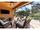 Screened lanai offering outdoor seating, a ceiling fan, and scenic backyard views at 5121 Serata Dr, Lakewood Ranch, FL 34211