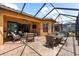 Spacious screened lanai offering outdoor seating and a dining table near the home's sliding door at 5121 Serata Dr, Lakewood Ranch, FL 34211