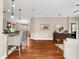 Spacious living room featuring wood floors, modern lighting, and a decorative mirror over dark wood credenza at 5121 Serata Dr, Lakewood Ranch, FL 34211
