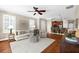 Open living space with hardwood floors connecting to the modern kitchen at 5121 Serata Dr, Lakewood Ranch, FL 34211