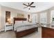 Bright main bedroom features a ceiling fan, stylish decor, and comfortable furnishings for relaxation at 5121 Serata Dr, Lakewood Ranch, FL 34211
