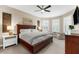 Bright main bedroom boasts natural light from shuttered windows and features a ceiling fan, and a plush seating area at 5121 Serata Dr, Lakewood Ranch, FL 34211