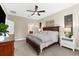Cozy main bedroom showcases a spacious layout with ensuite bathroom, warm paint colors and comfortable furniture at 5121 Serata Dr, Lakewood Ranch, FL 34211
