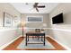 Bright office featuring a ceiling fan, hardwood floors, and a view to the exterior at 5121 Serata Dr, Lakewood Ranch, FL 34211