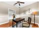 Bright office featuring a ceiling fan, hardwood floors, and a wooden desk with chair at 5121 Serata Dr, Lakewood Ranch, FL 34211