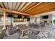 Inviting outdoor seating area with a fireplace, TVs, and an overhead pergola that creates a resort-style feel at 5121 Serata Dr, Lakewood Ranch, FL 34211