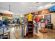 Well-stocked retail shop with diverse apparel, wood floors, display shelves, and ample lighting that creates a welcoming ambiance at 5121 Serata Dr, Lakewood Ranch, FL 34211