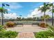 Well-maintained tennis courts with a picturesque view of palm trees and manicured landscaping under a bright sky at 5121 Serata Dr, Lakewood Ranch, FL 34211
