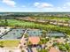 Aerial view of tennis courts near a golf course and luxurious homes on a sunny day at 5121 Serata Dr, Lakewood Ranch, FL 34211