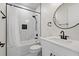 Elegant bathroom featuring white marbled tile walls, a shower with a black trim, and a sleek black faucet at 5339 Gulfport Ter, Port Charlotte, FL 33981