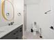 Stylish bathroom featuring a sleek vanity with black fixtures, modern oval mirror, and neutral toned walls and floors at 5339 Gulfport Ter, Port Charlotte, FL 33981