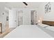 Bright bedroom with wood floors, white walls and doors, and ensuite bath and closet at 5339 Gulfport Ter, Port Charlotte, FL 33981