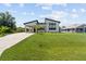 Striking modern home with lush lawn, covered parking, and charming front yard landscaping at 5339 Gulfport Ter, Port Charlotte, FL 33981