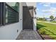 Contemporary home exterior with a dark gray front door and paved walkway at 5339 Gulfport Ter, Port Charlotte, FL 33981