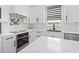 Spacious kitchen boasts stainless steel appliances, modern hardware, and bright white cabinets at 5339 Gulfport Ter, Port Charlotte, FL 33981