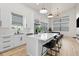 This well lit, open kitchen has a quartz island, stainless appliances and hardwood flooring at 5339 Gulfport Ter, Port Charlotte, FL 33981