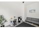 Bright room, perfect for an office, features gray love seat, a modern desk and neutral toned walls and flooring at 5339 Gulfport Ter, Port Charlotte, FL 33981