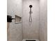 Tiled shower offers a modern rain shower head and built in shelf for storage at 5339 Gulfport Ter, Port Charlotte, FL 33981