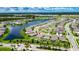 Aerial view of community homes with a large lake, palm trees, and a red pin showing the location of the house at 5521 Olano St, Palmetto, FL 34221