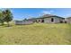 Wide shot of backyard with lush grass and a view of the above-ground swimming pool and back of the house at 5521 Olano St, Palmetto, FL 34221
