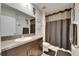 Bathroom with a vanity, shower, and toilet with a grey shower curtain, dark mat, and granite countertops at 5521 Olano St, Palmetto, FL 34221