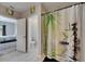 Bathroom area showcasing a shower and toilet through doorway with a decorative shower curtain at 5521 Olano St, Palmetto, FL 34221