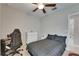 Well-lit bedroom with neutral tones, a ceiling fan, and a queen-sized bed with checkered bedding at 5521 Olano St, Palmetto, FL 34221