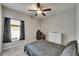 Cozy bedroom featuring a ceiling fan, plush carpet, and a window with blinds and black-out curtains at 5521 Olano St, Palmetto, FL 34221