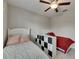 Bright bedroom featuring two twin beds, ceiling fan, and decorative storage unit at 5521 Olano St, Palmetto, FL 34221