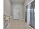Bright foyer with tile flooring, elegant console table, and decorative curtains at 5521 Olano St, Palmetto, FL 34221