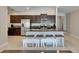 Kitchen featuring an island with barstool seating, dark cabinets, and stainless steel appliances at 5521 Olano St, Palmetto, FL 34221