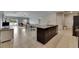 Open-concept kitchen with granite countertops and stainless steel appliances, flowing into living area at 5521 Olano St, Palmetto, FL 34221