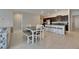 Open-concept kitchen featuring stainless steel appliances, granite countertops, and a dining area at 5521 Olano St, Palmetto, FL 34221