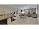 Open-concept living space featuring a kitchen island, dining area, and comfortable seating area at 5521 Olano St, Palmetto, FL 34221