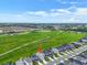 New two-story home with a long driveway in a community with a large green common area at 5540 Summit Gln, Bradenton, FL 34203