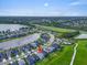 Home situated on a green lot near a lake and community pool, offering scenic views at 5540 Summit Gln, Bradenton, FL 34203
