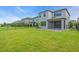 Large backyard showcases a well-manicured lawn, complemented by a paved patio and stylish fencing at 5540 Summit Gln, Bradenton, FL 34203