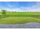 Expansive backyard features a lush lawn, complemented by a paved patio area with an elegant fence at 5540 Summit Gln, Bradenton, FL 34203