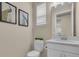 Well-lit half bath with white cabinetry, decorative art, and toilet at 5540 Summit Gln, Bradenton, FL 34203