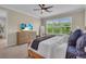 Bedroom featuring a large window, TV, ample dresser, and a comfortable bed at 5540 Summit Gln, Bradenton, FL 34203