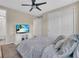 This is a peaceful bedroom with neutral tones and a large TV is the perfect place to wind down after a long day at 5540 Summit Gln, Bradenton, FL 34203